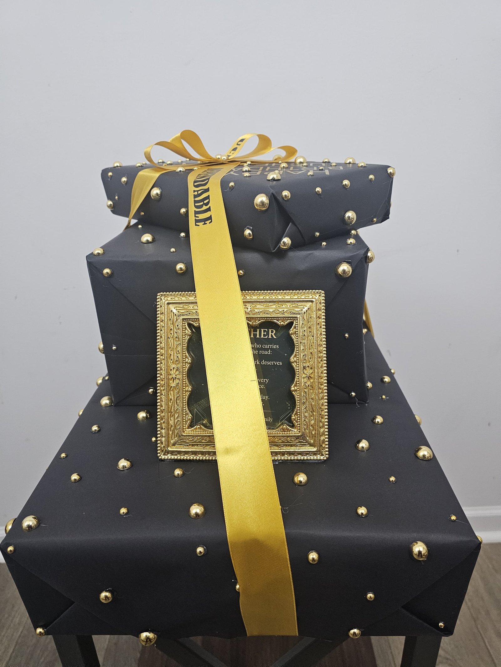 Front view of black and gold custom birthday gift stack