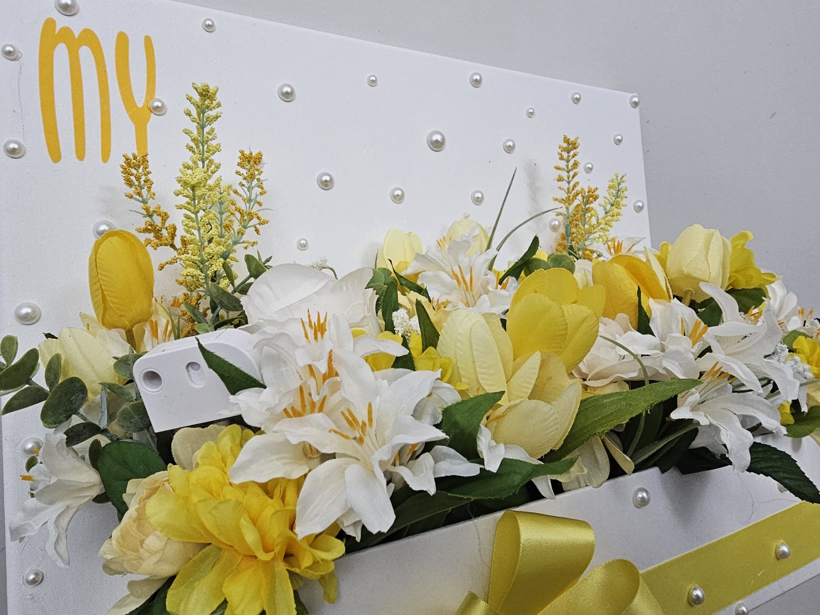 Close-up of yellow floral message board